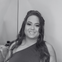 Thais, mulher branca de cabelos ruivos, sorrindo, em preto e branco.