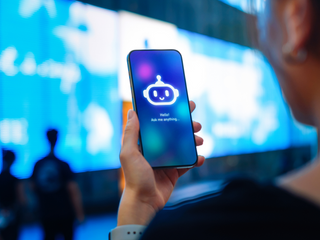 a person using a cellphone with the icon of a robot on its screen