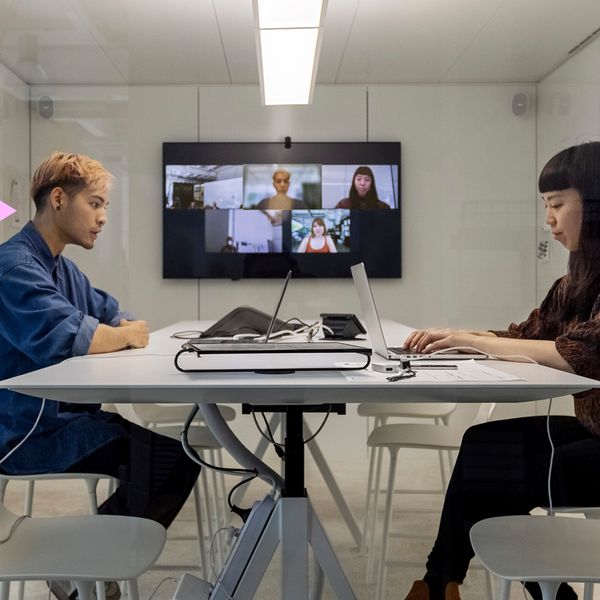 two business people working on their laptops