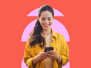 A woman in a yellow jacket holds a smartphone, standing against a orange background with pink geometric shapes.