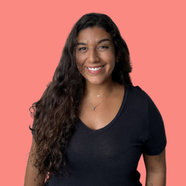 Vanessa, mulher parda de cabelo preto liso, sorrindo.