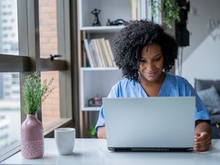 A woman looking at a computer screen