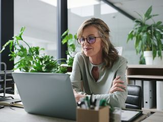 A woman looking at a computer screen