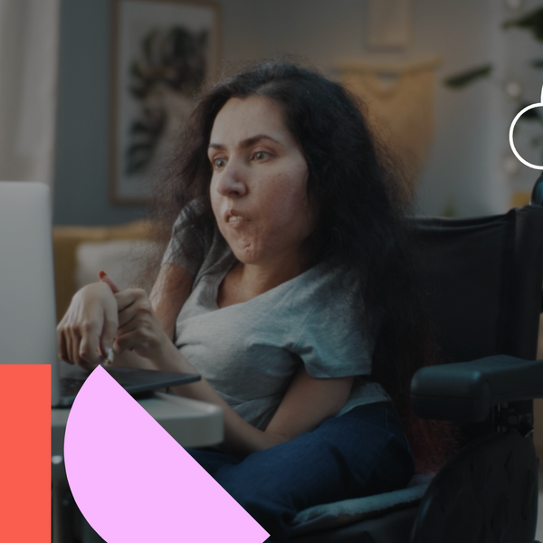 Woman with disability in a wheelchair at home browsing the internet