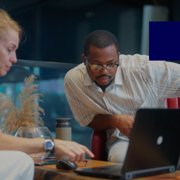 A businessman is meeting with a businesswoman in a modern office working space.