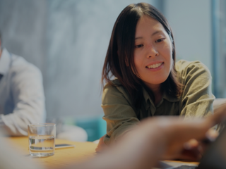 An Asian businesswoman is working on a laptop. 