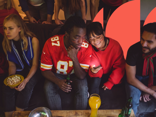 mixed group of young people watching a nfl game