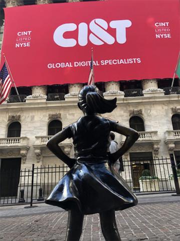 Fearless girl statue in front of ciandt facade banner at the NYSE